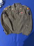 Original WWII U.S. Army uniform grouping attributed to John Reed, who served with the 16th Armored Field Artillery Battalion of the 9th Armored Division and later associated with the 102nd Infantry Division, known as the “Ozark” Division.