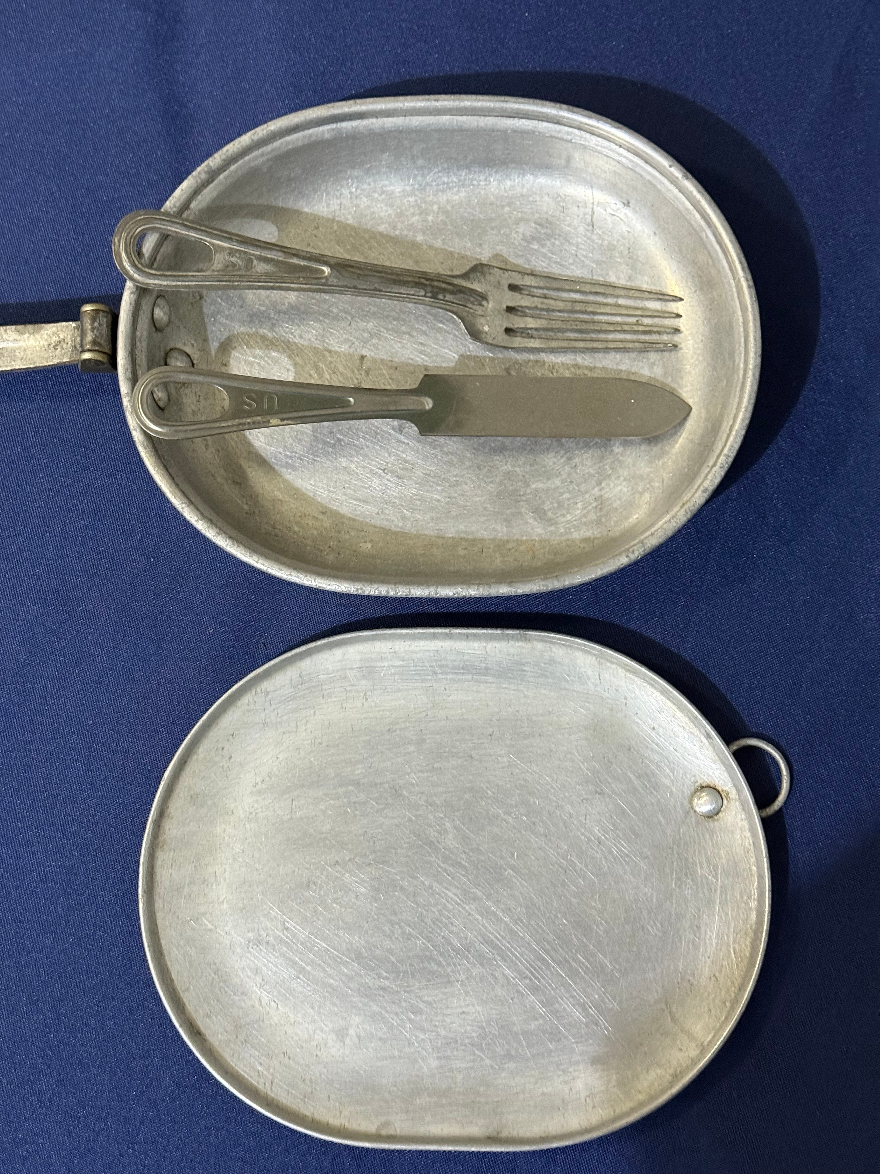 Original World War I-era U.S. mess kit, complete with its matching fork and knife. USMC and EGA on lid.
